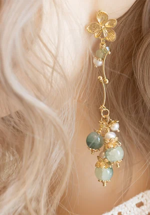side profile of model showcasing handmade jade pearl flower earrings with soft pastel glass accents