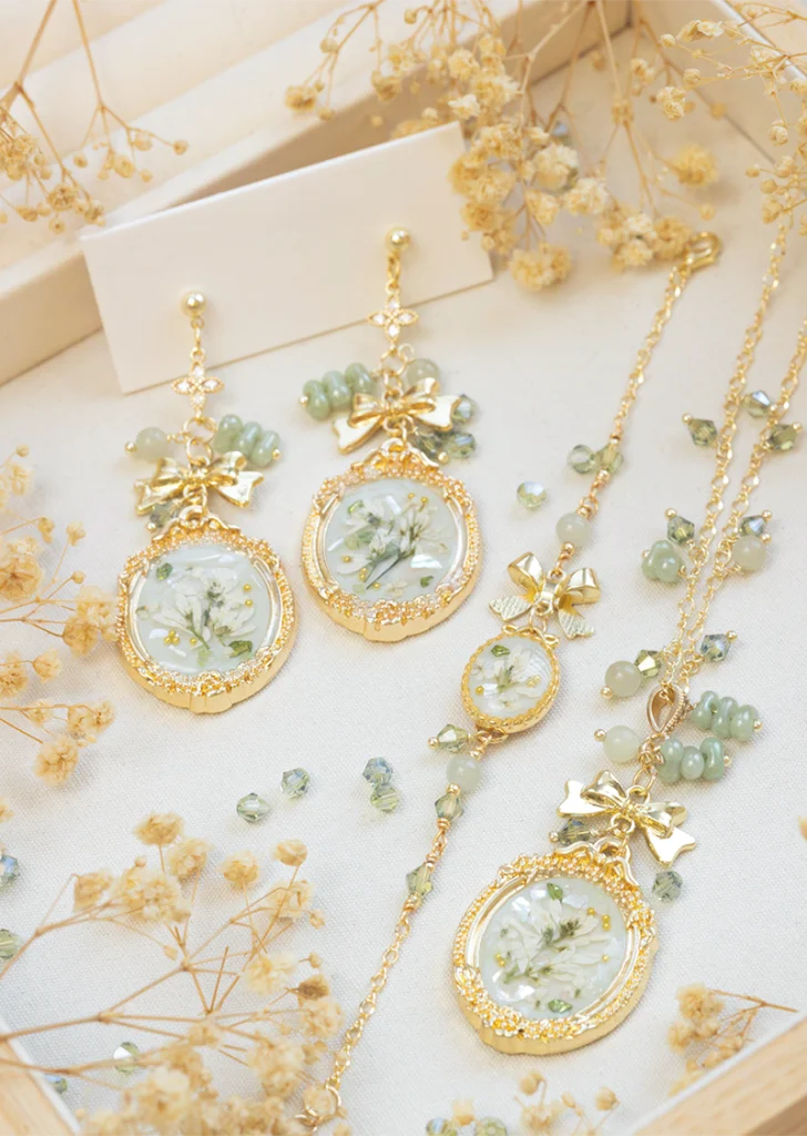 botanical resin jewellery set with rectangular earrings, oval earrings, bracelet, and necklace made with real flowers
